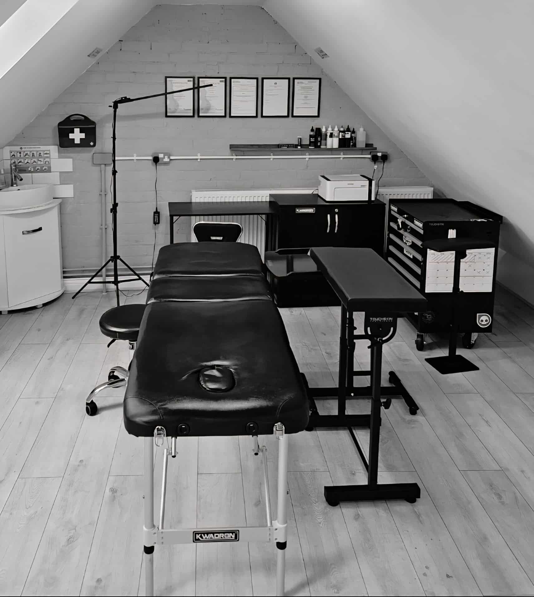 Inside the Inked Valour studio: tattoo bed, equipment and framed certificates